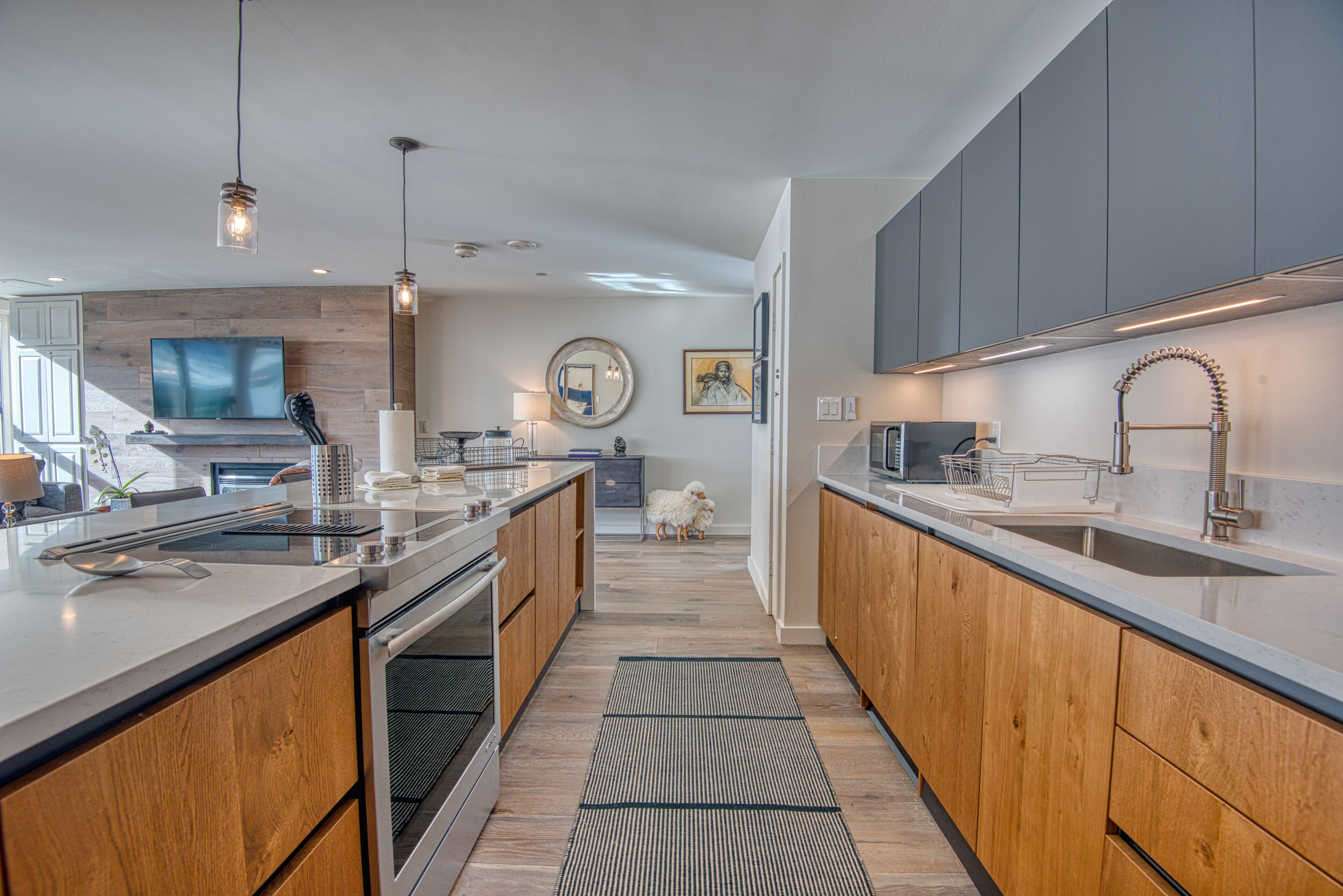 A modern kitchen with wooden cabinets, a large island, and a central island with a sink.