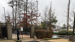 A parking area with EV charging stations and a gated entrance. - Wingate by Wyndham Little Rock (Little Rock)