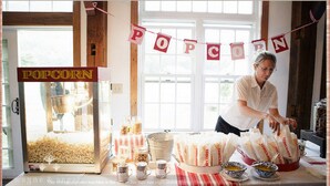 A vintage popcorn machine, a table with popcorn bags, and a window with a view. - 1824 House (Waitsfield)