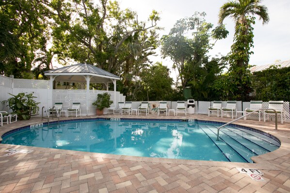 A heated pool, sun loungers