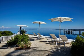 Beach nearby, white sand, sun loungers, beach umbrellas