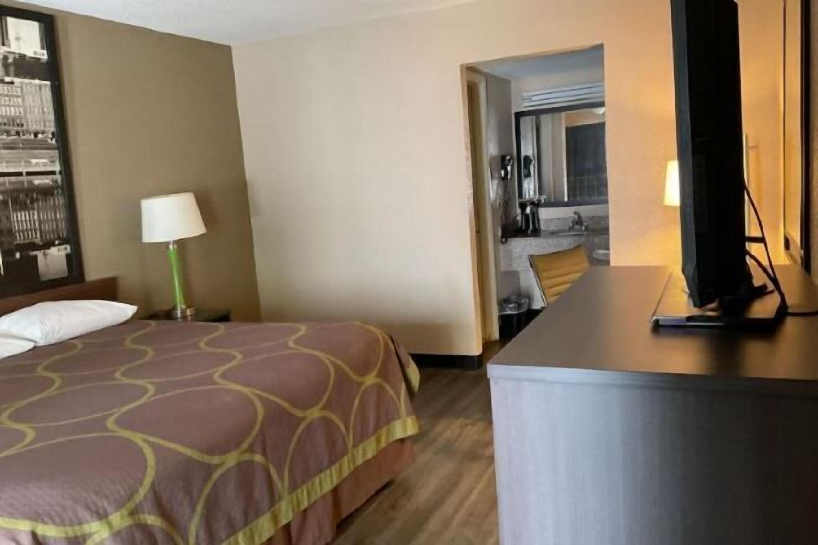 Premium bedding, desk, laptop workspace, blackout drapes