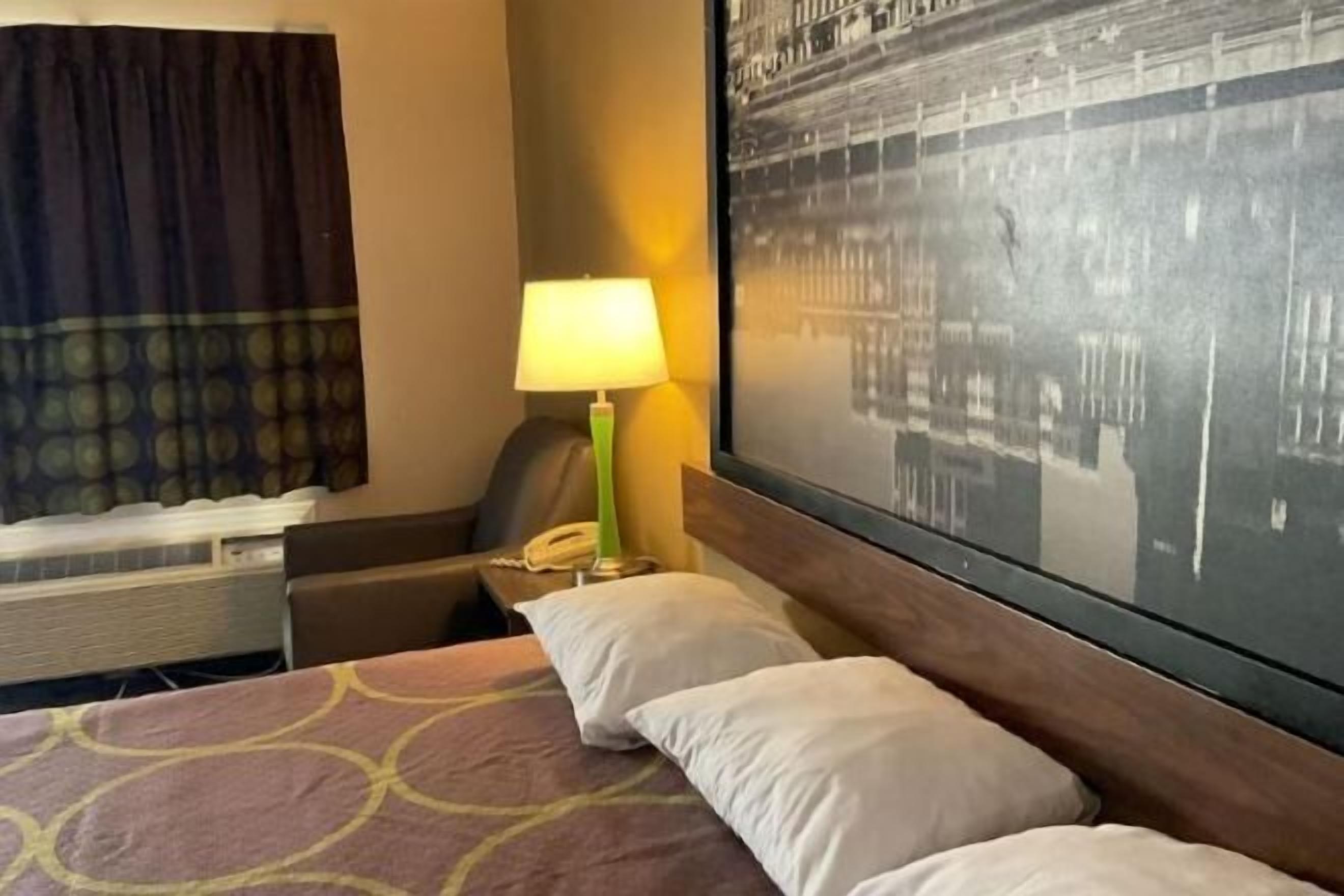 Premium bedding, desk, laptop workspace, blackout drapes