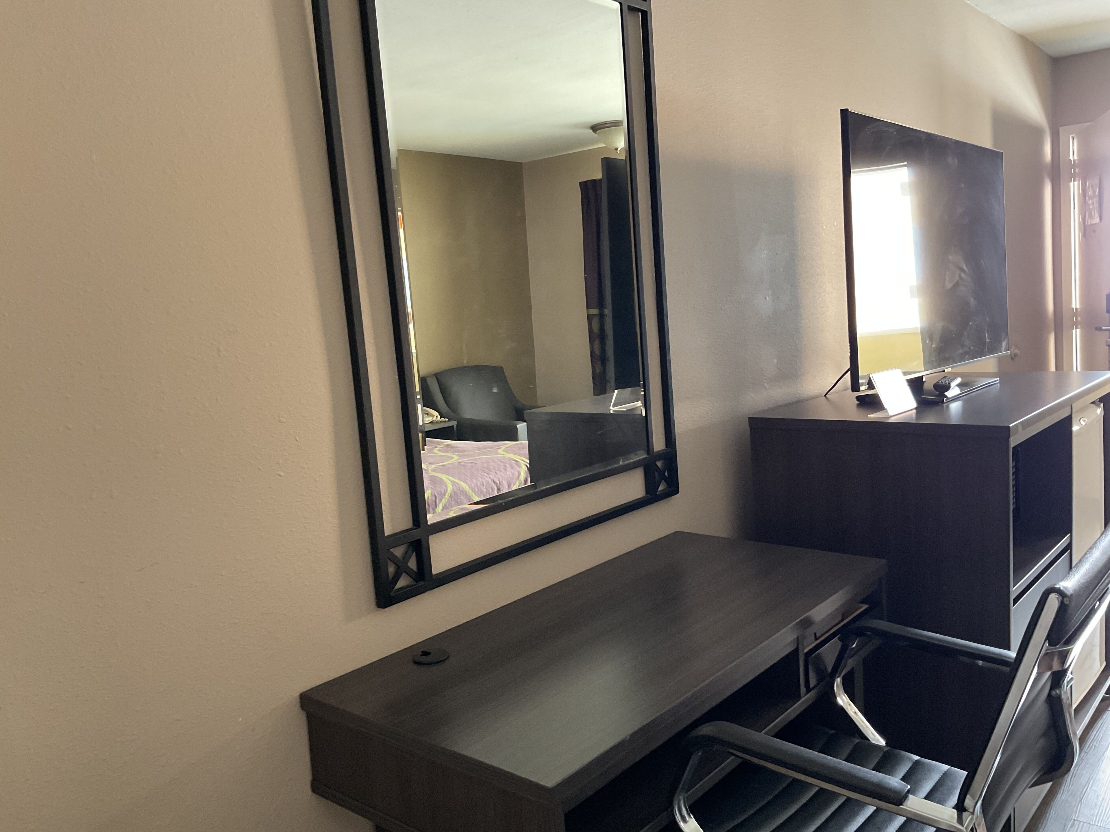 Premium bedding, desk, laptop workspace, blackout drapes