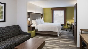 A hotel room with a bed, a sofa, a desk, and a chair. - Holiday Inn Express & Suites Saskatoon Centre by IHG (Saskatoon)