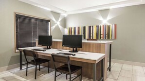 A modern office space with two desks, each equipped with a computer monitor, keyboard, and mouse. - Holiday Inn Express & Suites Regina-South by IHG (Regina)