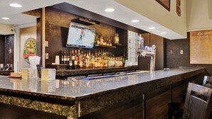 A bar area with a television screen displaying a hockey game, a variety of liquor bottles, and a menu board. - Superior Inn Hotel and Conference Centre Thunder Bay (Thunder Bay)