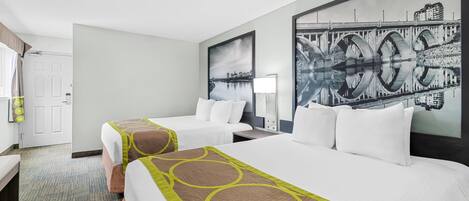 A hotel room with two beds, a large window, and a cityscape painting on the wall.