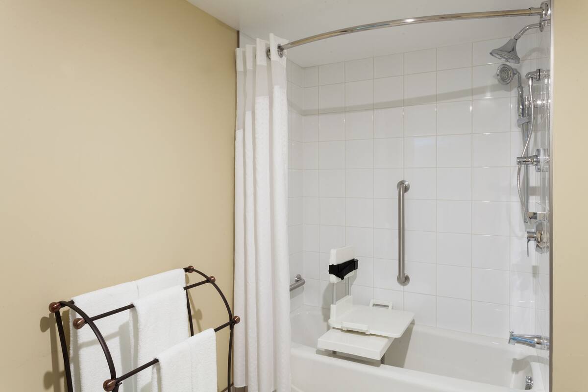 combined shower/bathtub, designer toiletries, hair dryer, towels