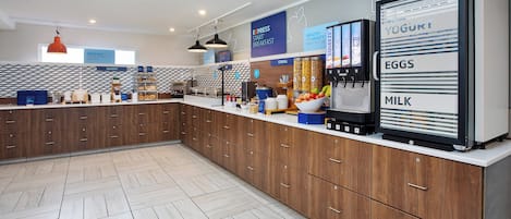 A modern kitchen with wooden cabinets, a breakfast bar, and a refrigerator stocked with dairy products.