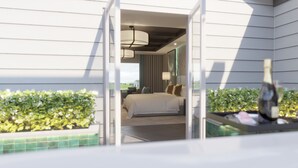 A hotel room with a bed, a nightstand, a lamp, and a view of the outdoors.