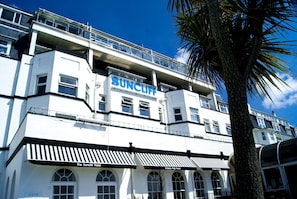 A multi-story hotel with a prominent 'SUNCLIFF' sign, featuring classic pub food and a rooftop bar. - Suncliff Hotel - OCEANA COLLECTION (Bournemouth)