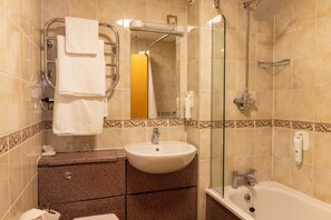 A bathroom with a sink, mirror, shower, and towel rack. - Weathervane Hotel by Greene King Inns (Stoke-on-Trent)