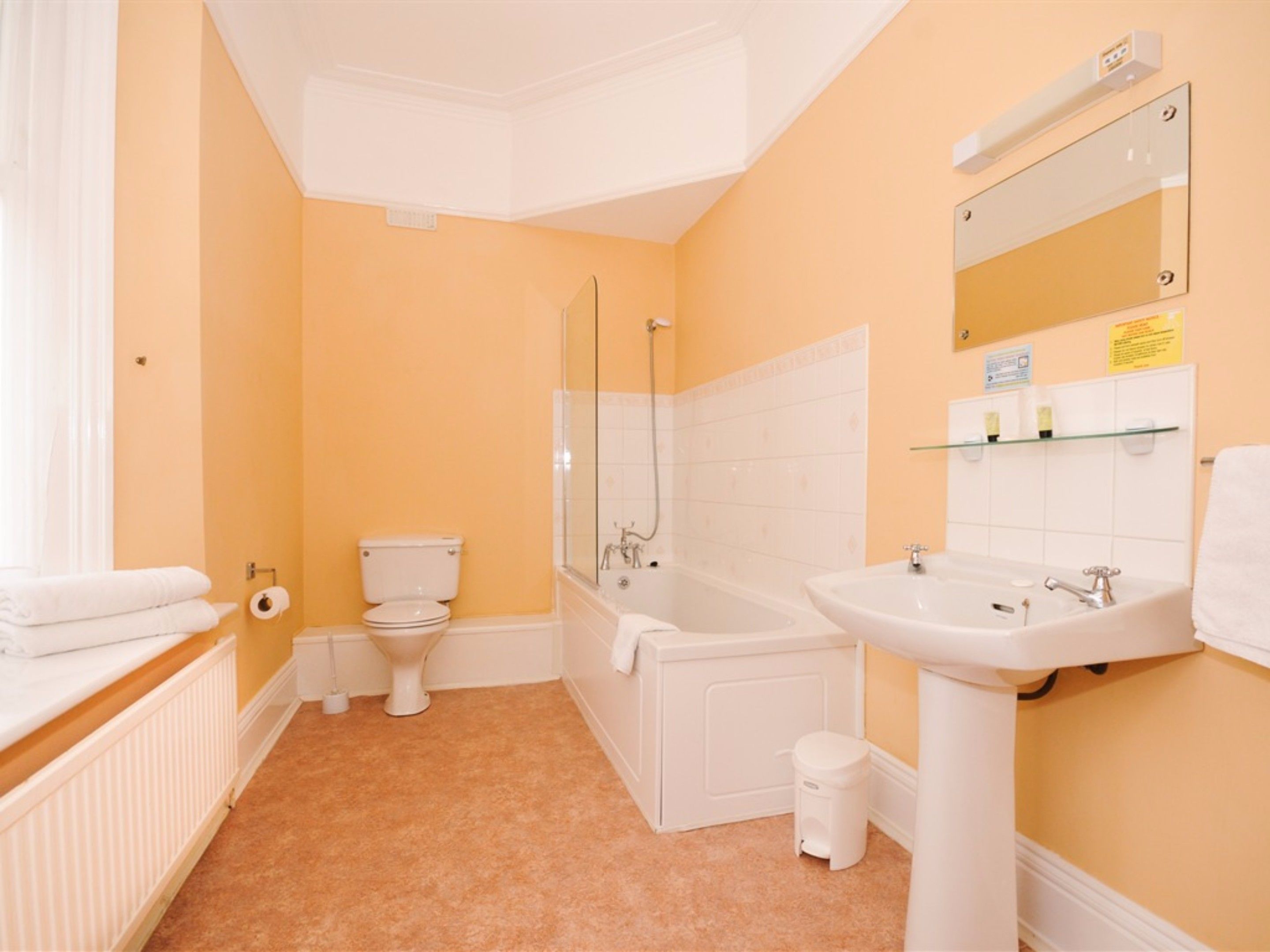 A bathroom with a toilet, bathtub, and sink.