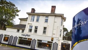 A two-story building with a sign reading "mayfair hotel" and a reception area visible through the windows. - The Mayfair Hotel (Bournemouth)
