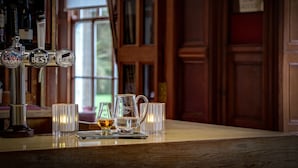 A bar area with beer taps labeled 'Coors Light,' 'Belhaven Best,' and 'Carlings.' There are glasses and a pitcher on the counter. - Best Western Balgeddie House Hotel (Glenrothes)