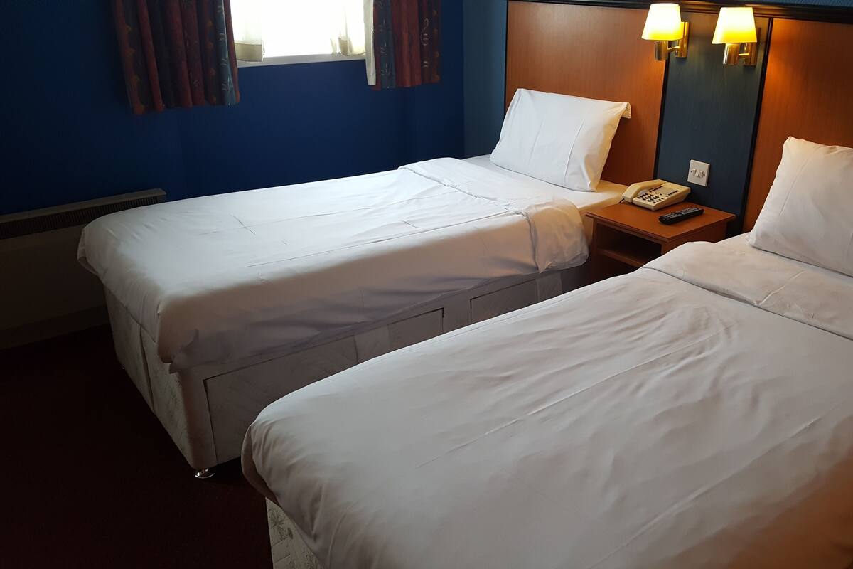 Desk, iron/ironing board, bed sheets