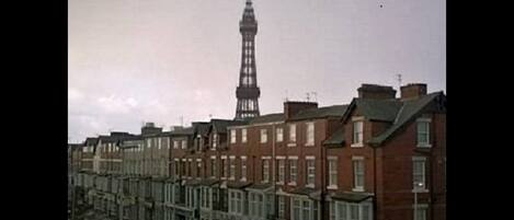 A row of terraced houses with a prominent tower in the background.