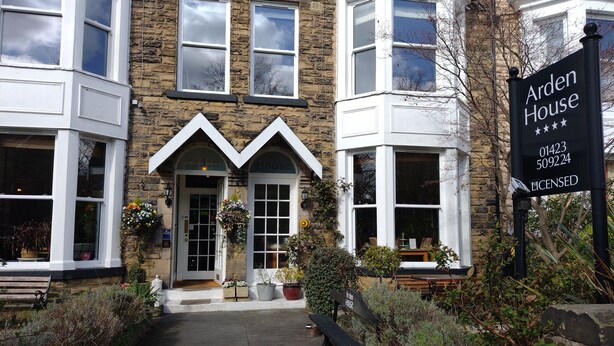 A stone building with a sign reading "Arden House" and a license plate number. - Arden House (Harrogate)