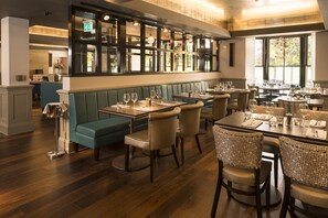 Enjoy a warm and inviting dining experience in this beautifully designed restaurant with elegant tables, comfortable seating, and a sophisticated atmosphere.