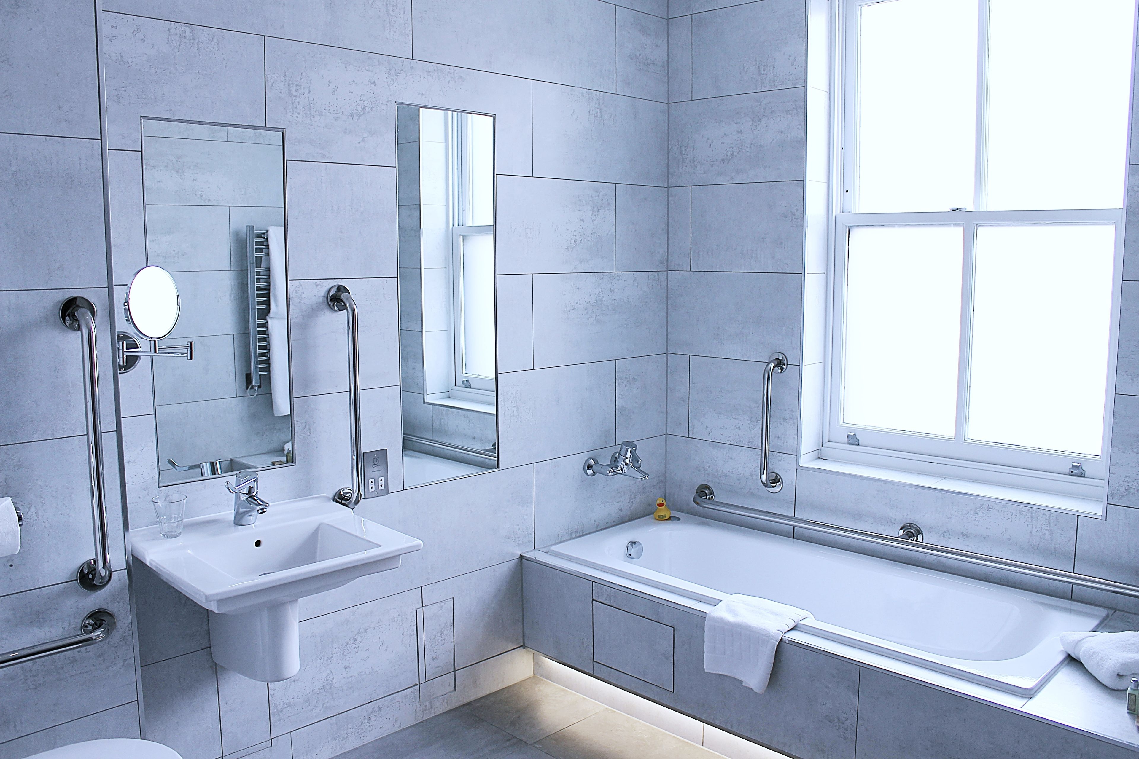 deluxe double room | bathroom | combined shower/bathtub, designer toiletries, hair dryer, bathrobes