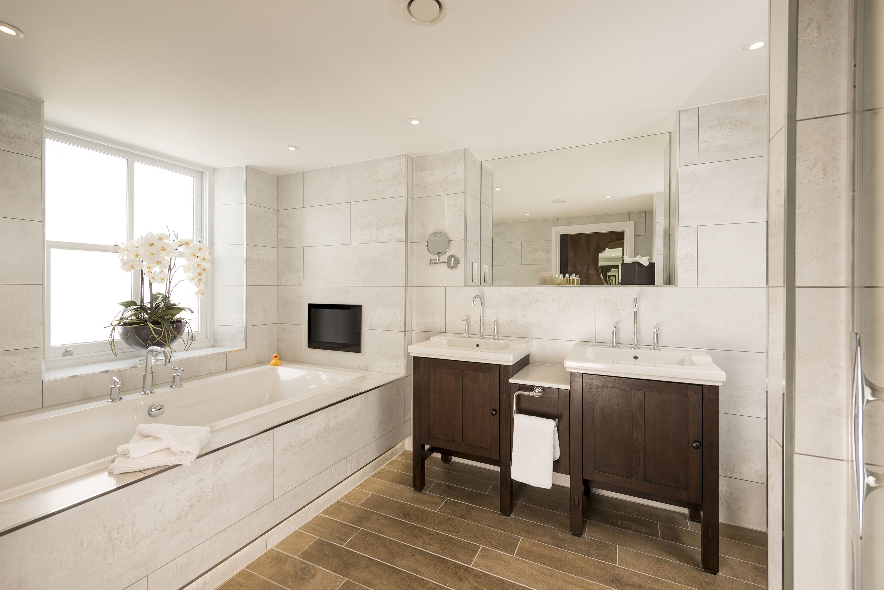 signature penthouse | bathroom | combined shower/bathtub, designer toiletries, hair dryer, bathrobes