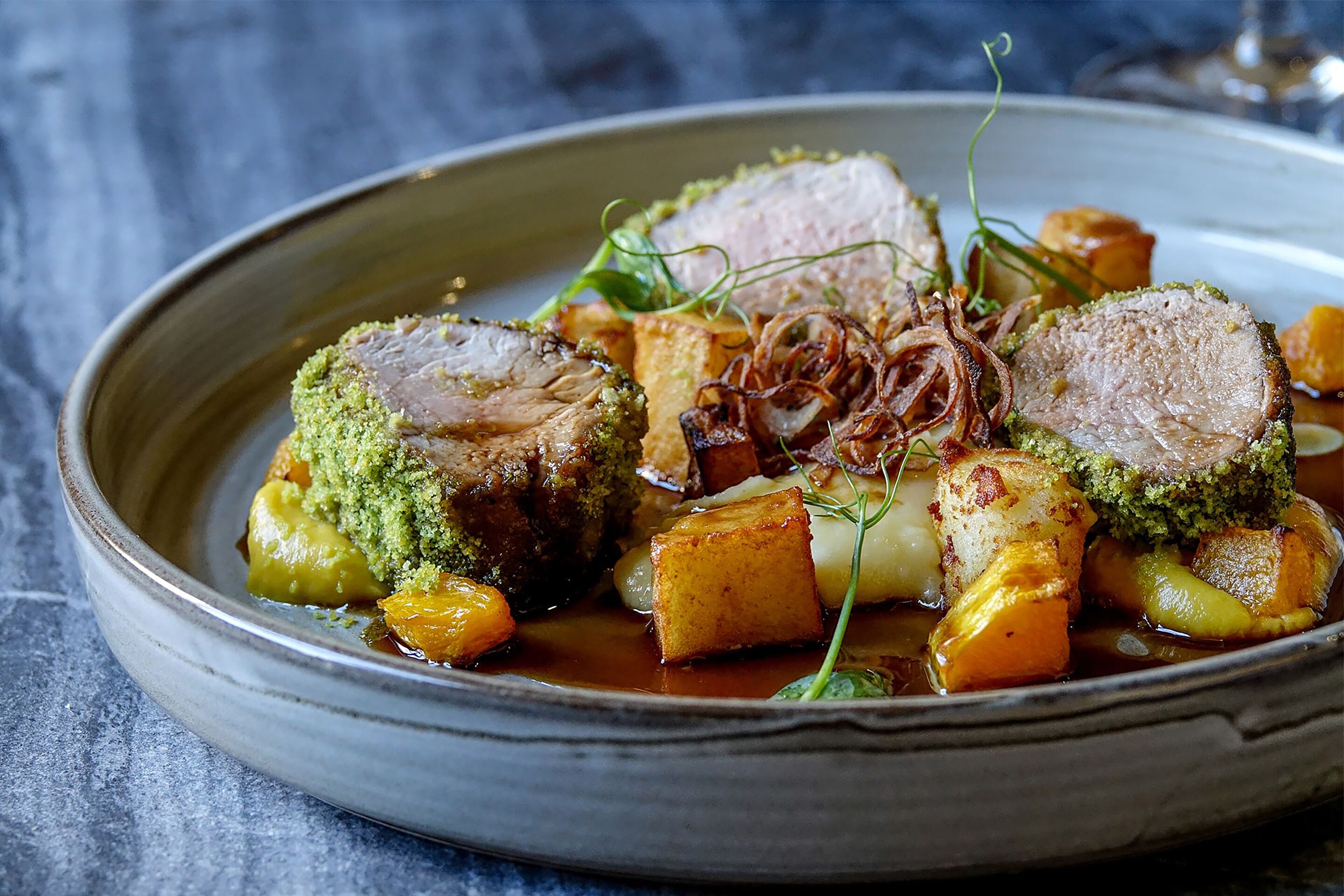 A plate of food with various vegetables and a piece of meat.