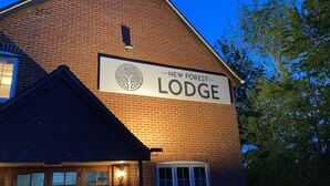 A brick building with a sign reading "New Forest Lodge." - New Forest Lodge (Salisbury)