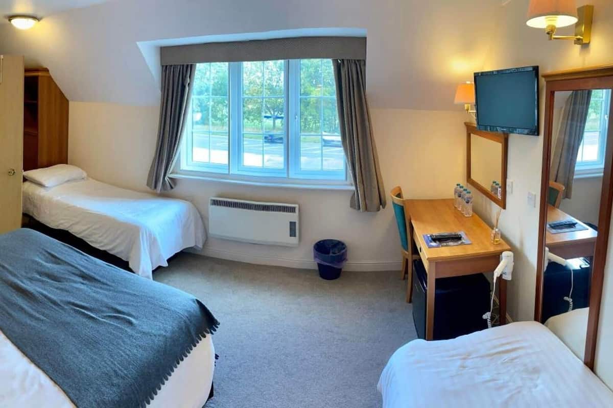 Premium bedding, desk, laptop workspace, iron/ironing board