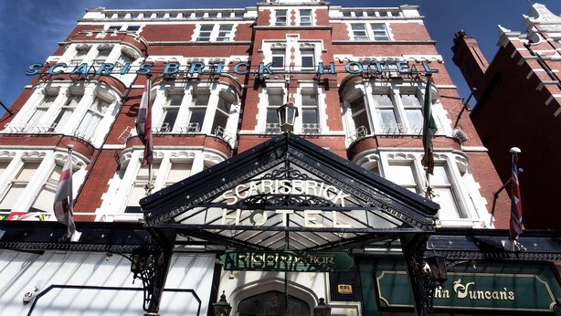 The Scaris Brick Hotel facade with a prominent entrance and signage for the adjacent "The King's Bar." - Scarisbrick Hotel (Southport)