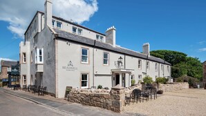 A two-story building with a sign reading "Beadnell Towers Hotel". - Beadnell Towers (Chathill)