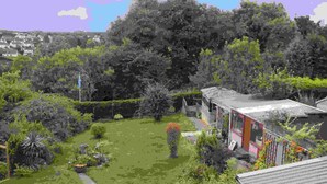 A residential area with a house, a garden, and a hill in the background. - Meadhon House (Jedburgh)