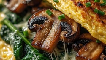 A plate with a grilled egg, mushrooms, and spinach.