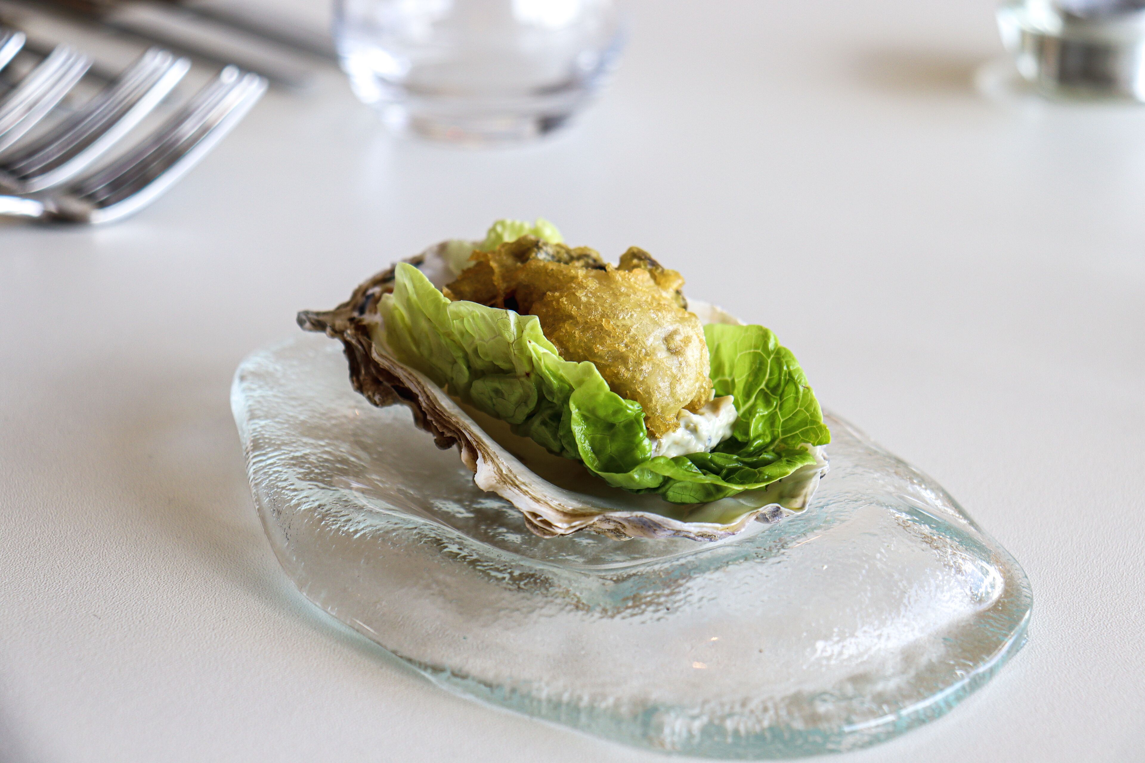A glass plate with a food item on it.