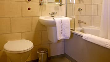 A bathroom with a toilet, sink, and bathtub.
