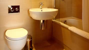 A bathroom with a toilet, sink, and bathtub.