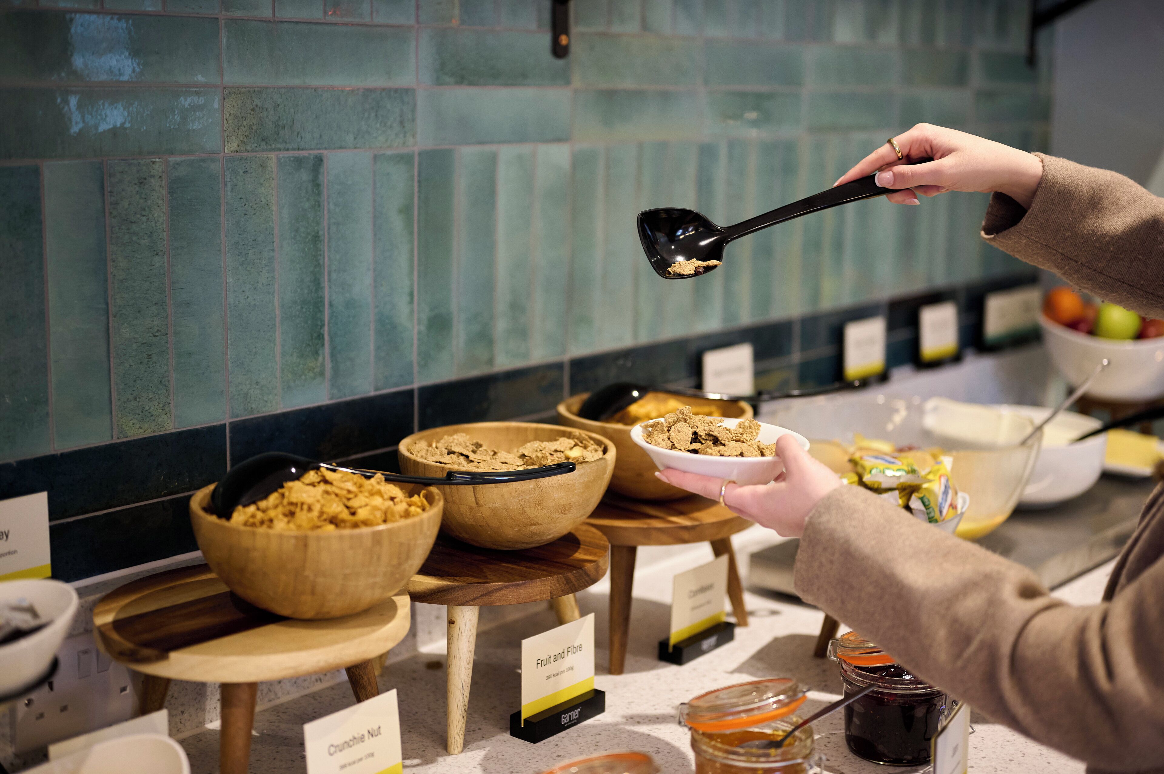 A buffet with various food items and labels, including 'Fruit and Fibre' and 'Crunchie Nut'.