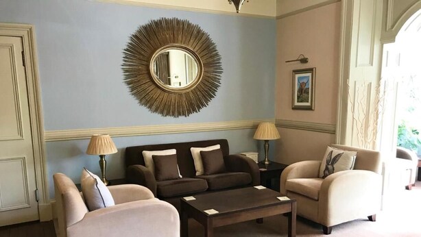 A living room with a sofa set, a coffee table, and two lamps.