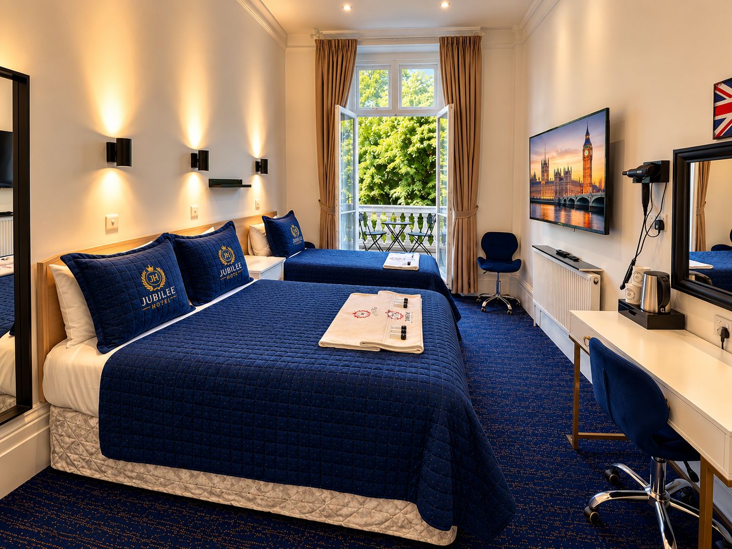 A hotel room with two beds, a desk, a chair, a television, and a window with a view of greenery.
