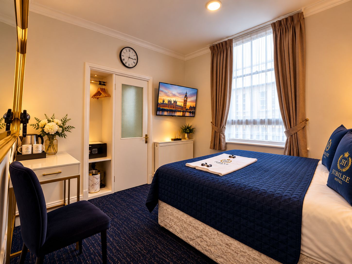 A hotel room with a bed, a desk, a chair, a clock, a painting, and a window with curtains.