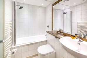 A modern bathroom with a shower, bathtub, toilet, and sink. - The California - Kings Cross St Pancras, London (London)