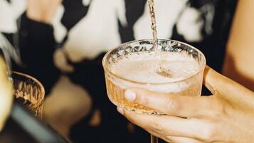 A person pouring a drink into a glass.