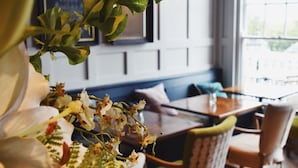 A room with a wooden floor, a table, chairs, and a window with daylight. - The Lookout Rye (Rye)