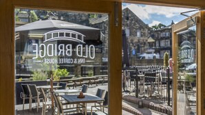 A restaurant with outdoor seating and a view of the town. - The Old Bridge Inn, Holmfirth, West Yorkshire (Holmfirth)