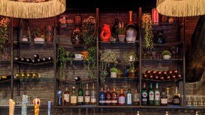 A bar with shelves of bottles and decorative items. - The Old Bridge Inn, Holmfirth, West Yorkshire (Holmfirth)