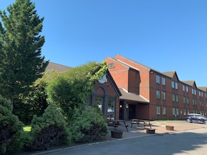 Hotel offers outdoor seating with picnic tables and a convenient trash bin.