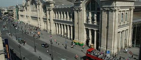 A large, ornate building with classical architecture, including columns and statues.