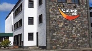 A modern hotel building with a white facade and a stone-textured corner. - Caladh Inn (Stornoway)