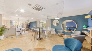 Ein modernes Interieur mit einer Rezeption, einer Sitzecke und einem Tisch mit Spiegel.