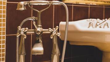 Un baño con bañera, ducha y lavabo.
